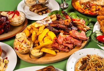 Plate with sausage, steak, grilled meat and potatoes, mix grill