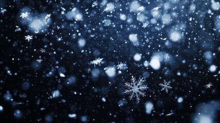 Obraz premium A close-up shot of snowflakes falling against a dark background.