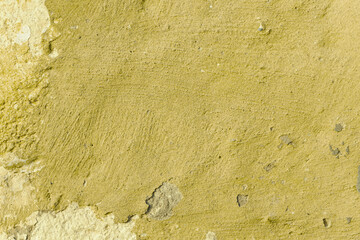 Grunge yellow concrete background. Textured plaster wall. Color of the year 2025 concept. Top view, layout for design. Surface with peeling shabby pattern.