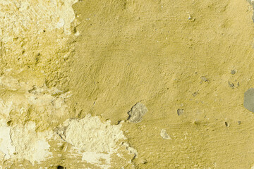 Grunge yellow concrete background. Textured plaster wall. Color of the year 2025 concept. Top view, layout for design. Surface with peeling shabby pattern.
