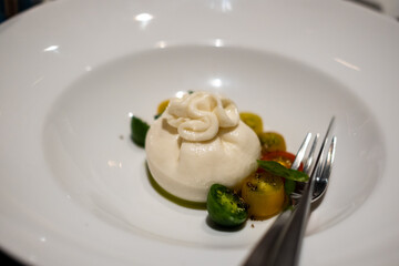 Burrata, an Italian cow's milk cheese made from mozzarella and cream, served on plate