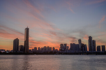 Sunset and silhouette view of 63 Building and high rise buildings of financial district with Wonhyo...