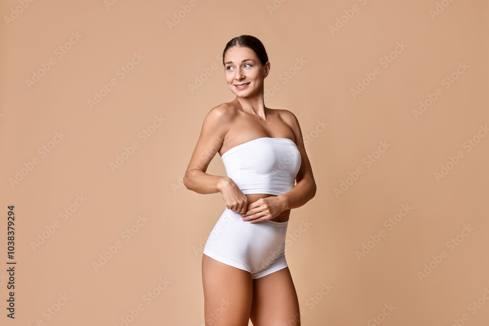 Canvas Prints Smiling woman with perfect skin posing on beige background. Body care