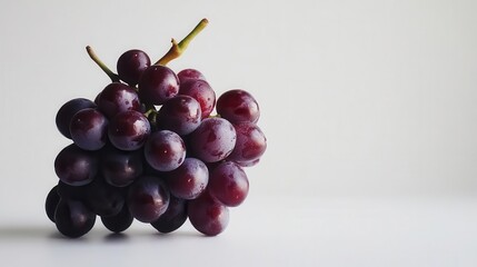 Fototapeta premium a fresh bunch of red grapes against a pure white background, emphasizing their rich color and texture, perfect for food photography and healthy lifestyle concepts