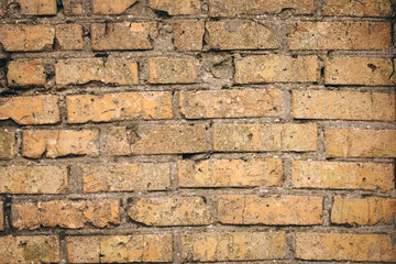 Non-linear pattern of an old shabby brick wall with natural patterns of paint chips. Restoration of semi-antique brick walls. A basic neutral background for a design project.