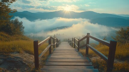 Obraz premium Wooden staircase leading up to a mountain peak with a breathtaking view of the clouds and the setting sun.