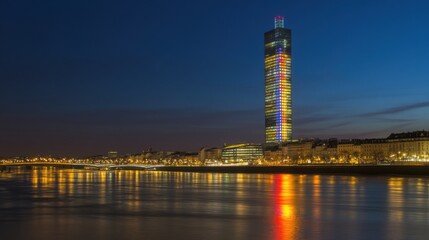 Naklejka premium Illuminated Skyscraper in Nighttime Cityscape