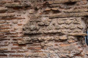 Ancient stone and brick wall with weathered textures, showcasing rustic and historical elements. Ideal for backgrounds, archaeology themes, or historical architecture projects.