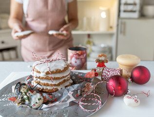Homemade christmas gingerbread cookies fresh decorated by a woman in the kitchen. Traditional german elisen gingerbread