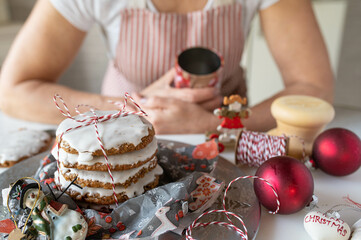 Homemade christmas gingerbread cookies fresh decorated by a woman in the kitchen. Traditional german elisen gingerbread