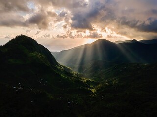 Scenic Mountain Valley with Sun Rays at Sunrise.