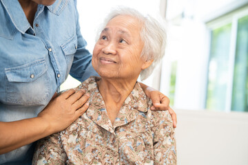 Caregiver help and care Asian senior woman patient with love, encourage and empathy in hospital.
