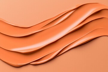 Abstract orange texture with smooth, flowing waves on a neutral background.