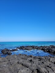 The sea blends in with the basalt