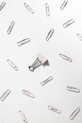Stationery, paper clips, binder on a white background. Top view, flat lay