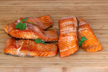 Deliciously Grilled Salmon Fillets Arranged Beautifully on a Rustic Wooden Board
