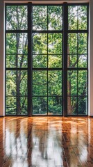 Large modern window overlooking lush greenery, bringing natural light into the spacious room with polished wooden floors.