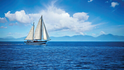 Fototapeta premium Panorama of the blue ocean with reflections of the sun. Vast sea ripples and calm sea with sunshine and sailboats