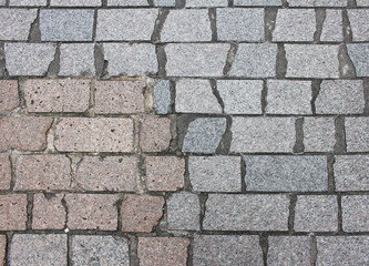 Texture of cobblestone. Pattern of sidewalk tiles in the street. Cobblestones close up. Gray Pavement background.	