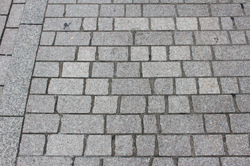 Texture of cobblestone. Pattern of sidewalk tiles in the street. Gray Pavement background.	