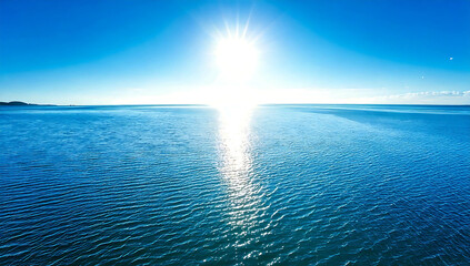 Panorama of the blue ocean with reflections of the sun. vast open sea ripples and the calm sea with beautiful sunshine and sunsets.