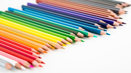 Colored pencils lying in irregular row