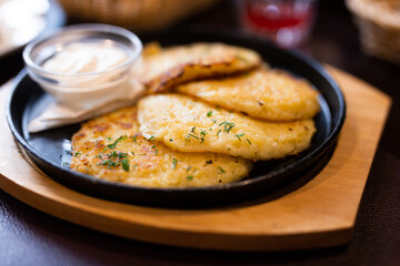 Belarusian cuisine. Potato draniki stew with sour cream