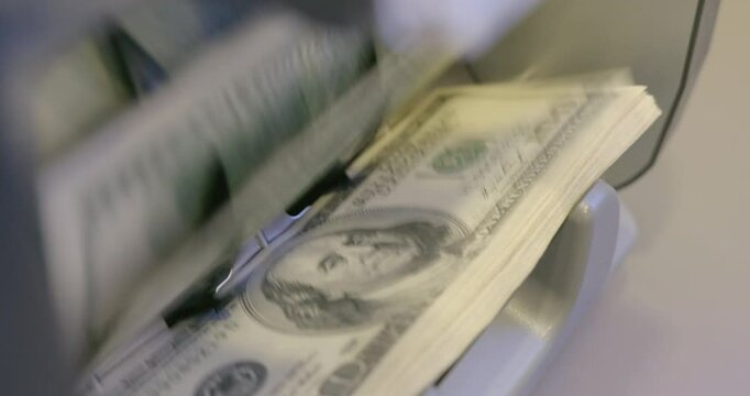 High quality video 6k 4:2:2 10bit downscale 4k .100 dollar bills counted in money counting machine. Cash money dollars into banknote counter. 