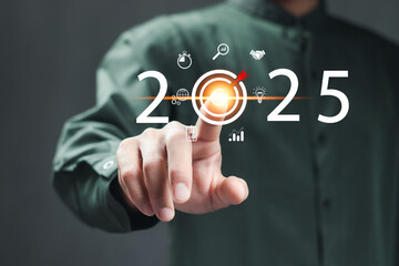 Businessman touching target icon on virtual screen. Startup business 2025. merry Christmas and happy new year concept..