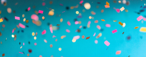 Falling gold confetti on vibrant blue background creates festive and joyful atmosphere, perfect for celebrations and special occasions