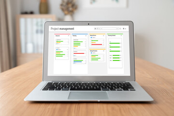 Project planning software for modish business project management on the computer screen showing timeline chart of the team project