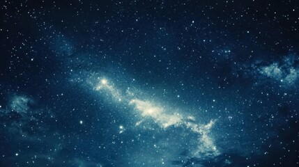 Naklejka premium An evening sky with a rich blue tone, sprinkled with stars and the faint glow of the galaxy's core.