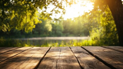 Fototapeta premium An empty wooden table with a soft blur of a summer lake and lush green forest in the background, evoking tranquility.