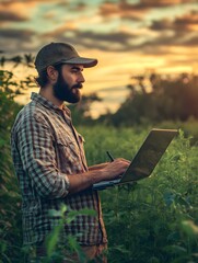 Obraz premium Farmer checking real-time weather conditions and crop growth projections on a laptop while standing in a vibrant field, integrating technology into daily farm management