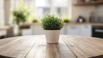 Empty round wooden table with a potted plant centerpiece, blurred kitchen background, perfect for cozy home decor display.