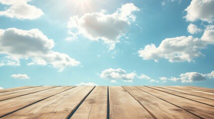 Empty wooden table against a serene sky with soft clouds, ideal backdrop for summer or outdoor product presentations.