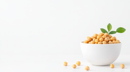 Fresh chickpeas in a white bowl with green leaves