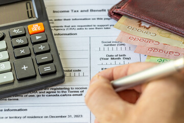 Income tax return in Canada. Financial concept. Tax form, Canadian dollars and tax calculation on...