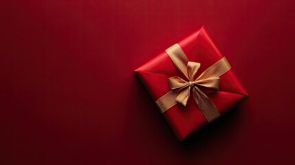 A luxurious red gift box with a golden ribbon neatly tied on top, creating an elegant and festive presentation on a clean background.