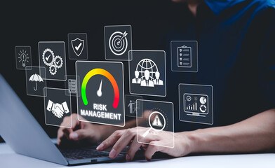 Corporate risk management strategy concept. A businessman is analyzing a virtual risk management interface with critical strategy icons on a laptop screen. Analyze risk assessment, analysis financial,