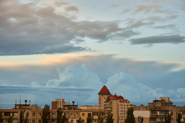 Cityscape with Towering Clouds and Evening Light