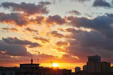 Sunset Behind Clouds with City Silhouettes