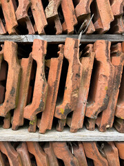 Closeup of orange ceramic tiles, stacked vertically