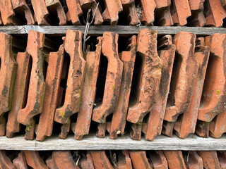 Closeup of orange ceramic tiles, stacked vertically