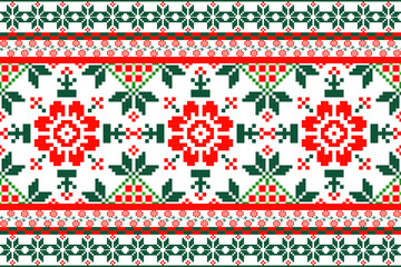 a traditional textile design, with a prominent red and green floral pattern on a white background. The motifs are symmetrical, resembling cross-stitch or embroidery, and are framed with decorative