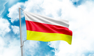 South Ossetia flag waving on sky background. 3D Rendering