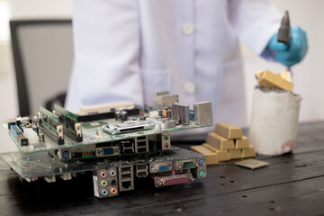 Technicians meticulously repair electronic components to turn them into precious gold. This process...
