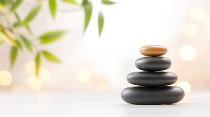 Obraz premium Stacked basalt stones create a peaceful atmosphere complemented by bamboo, enhancing relaxation and mindfulness