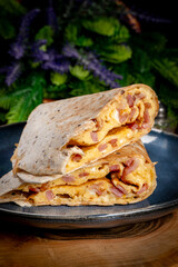 Tortilla multigrain with omelette, sausage and bacon.