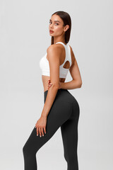 Fitness woman. Athletic girl on the gray background